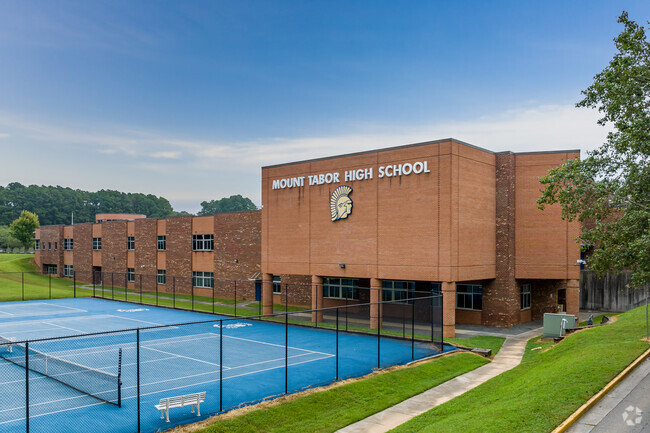 Student athletes train for tennis matches on the courts at Mount Tabor High School.