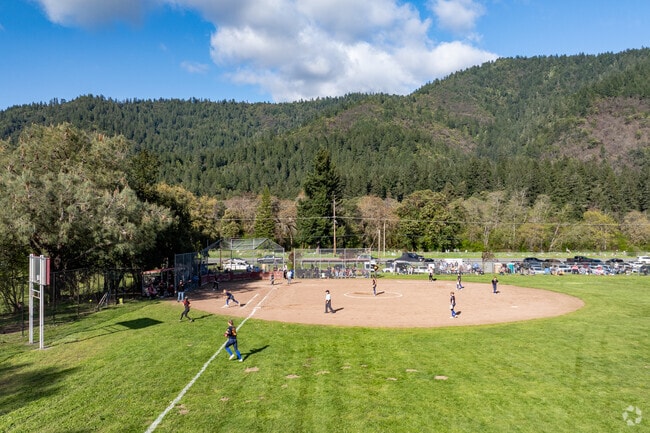 Hoopa youth play a softball game against a neighboring school team at Hoopa Valley Elementary School.