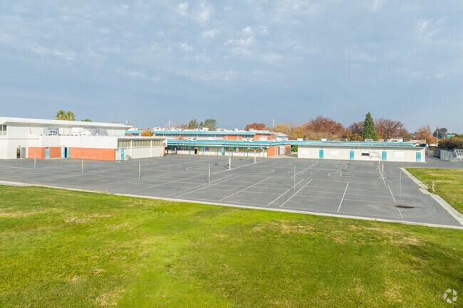 Students can play basketball on the blacktop at Fern Bacon Middle School.