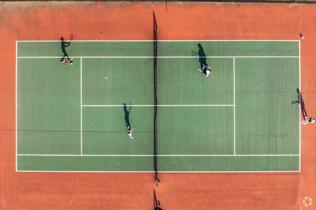 Tennis players practice at Lake Quinsigamond State Park tennis courts near Hamilton.