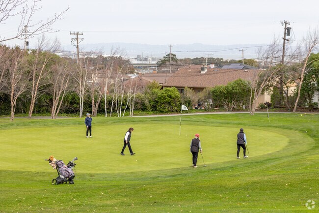 Golfers enjoy a round with scenic views at the Green Hills Country Club in Millbrae.
