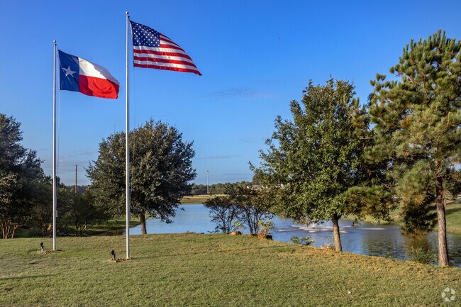 Large Texas and American flags wave proudly at the entrance of Valley Ranch.