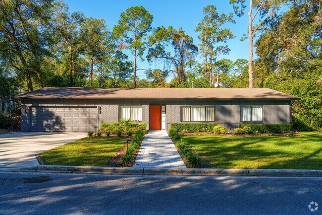 A beautiful paver entry leads to this well-maintained single-family home in Black Acres.
