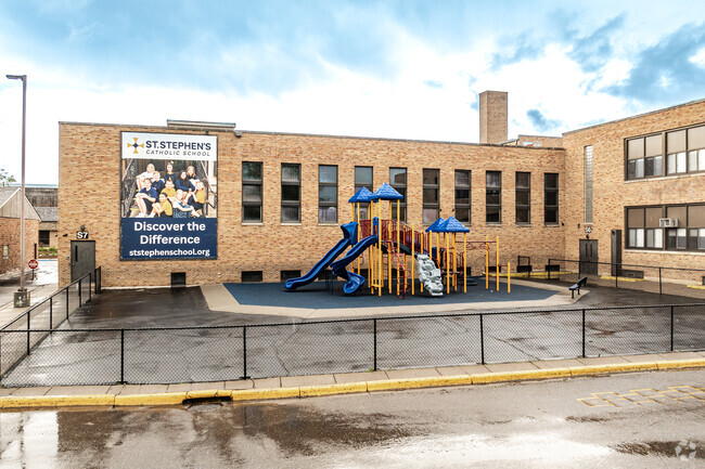 St. Stephen's Catholic School features a fenced in playground and blacktop area for recess.