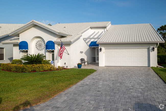 Ranch home with arches and decorative awnings over windows