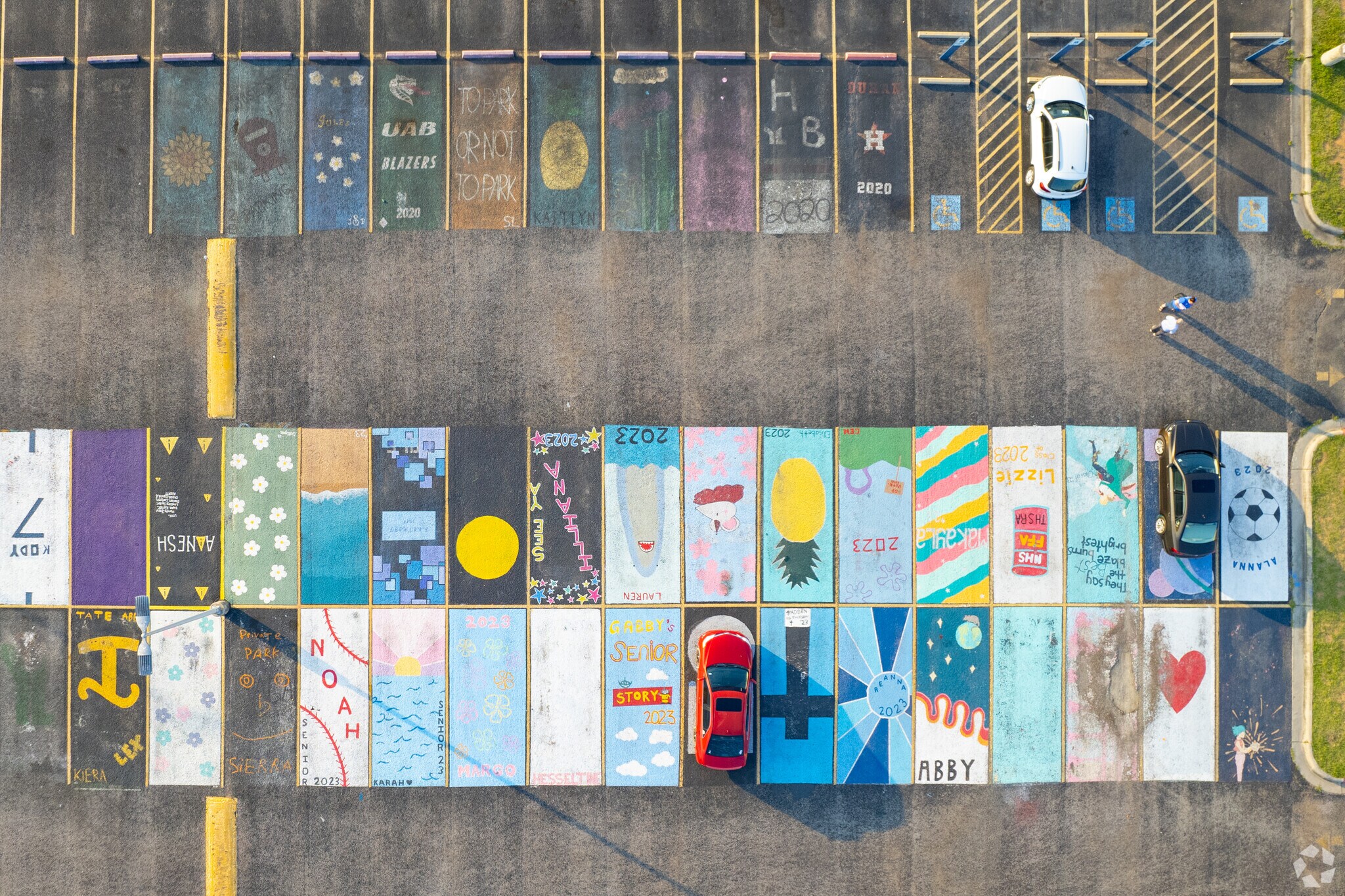 Students paint the parking lot of Gregory-Portland High School.