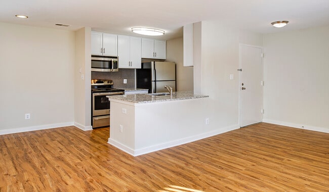 Large living room area with wood flooring throughout