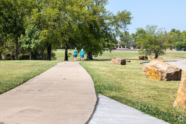 Walkers enjoy the warm air at Leake Park in Tulsa.
