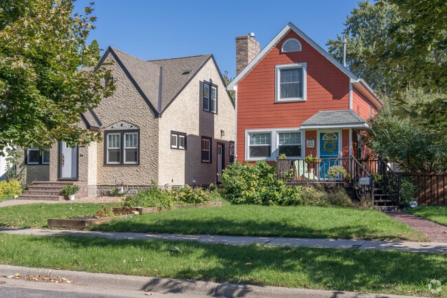 A traditionally remodeled red home with a blue door in Saint Paul's Highland Park neighborhood.