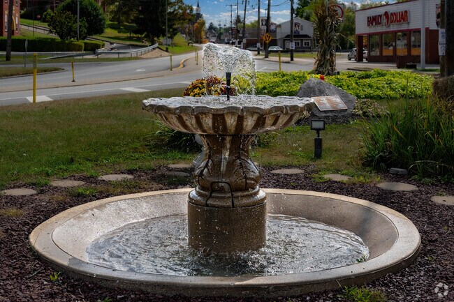 A beautiful fountain flows as people drive by the memorial square in Burgettstown.