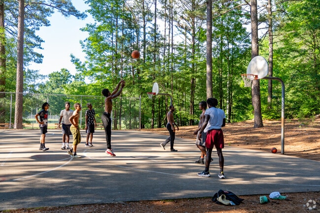 Kids play pickup basketball at Sanderford Road Park in South Raleigh.