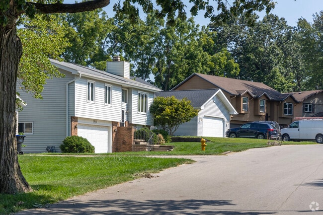 Homes in Oakwoods sit beneath mature trees that shade the winding streets.