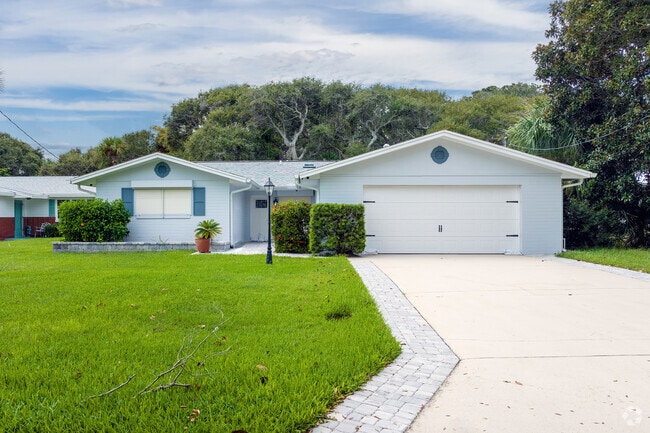 This ranch-style home sports a light blue color to enhance the Daytona Beach Shores vibe.
