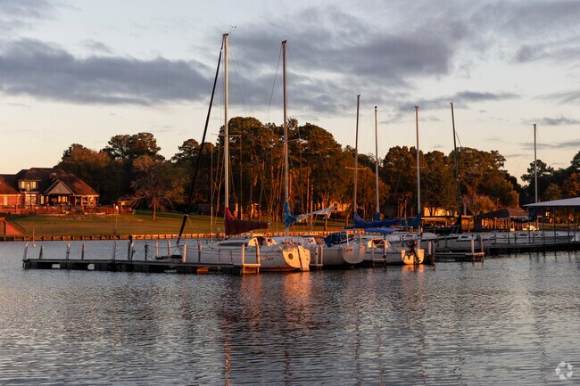 The sun bathes the sails boats in its golden light at a Marina in Bent Water.