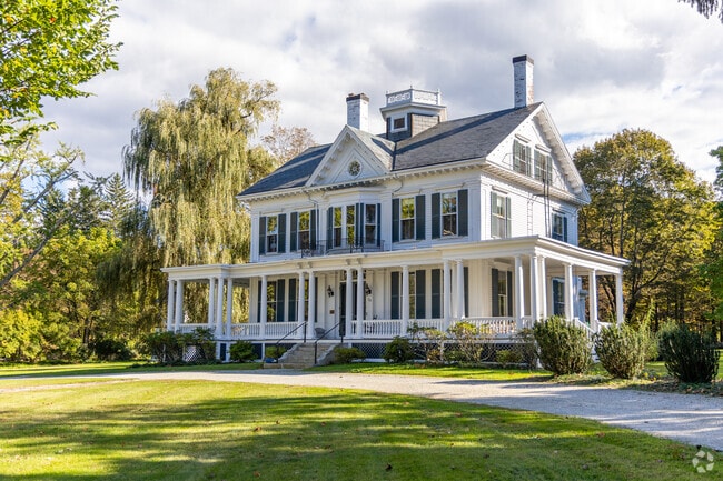 This elegant Colonial Revival home features a wraparound porch.