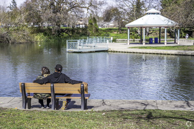 A couple sit and enjoy watching the ducks at Howe Community Park near Bellview.