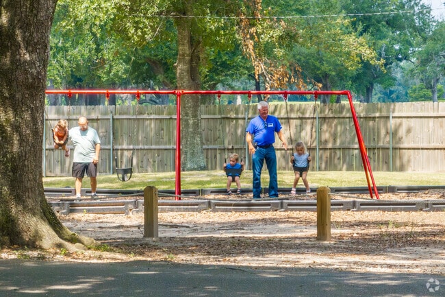Families enjoy playing on the swings at Frasch Park in Sulphur.