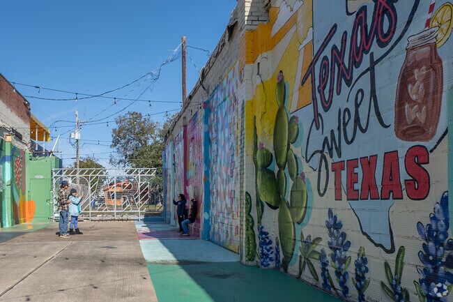 A Baytown family enjoys the murals located in the downtown art district.