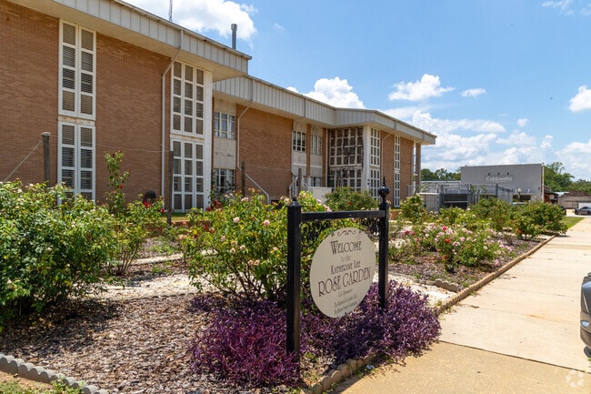 The Eunice & James L. West Rose Garden welcomes visitors with vibrant blooms and a scenic path.