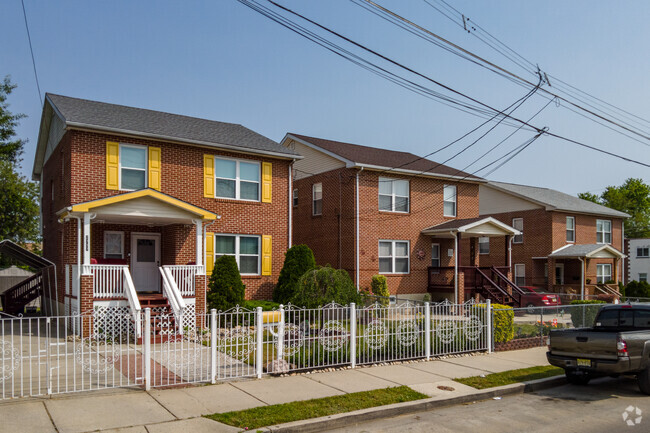 Brick Four Square homes with colorful shudders add splashes of color to Cramer Hill.