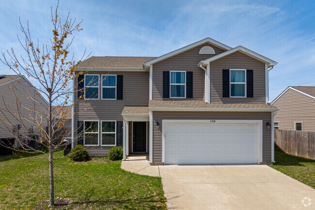 Bridge Water is full of New Traditional properties that have a modern look with brick and beige vinyl siding and two-car garages facing the street.