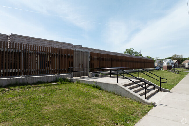 So modern wood slats run one whole side of the building creating privacy and shade.