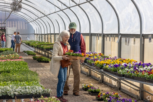 Residents of Smithville-Sanders enjoy looking for spring flowers at Mays Greenhouse.