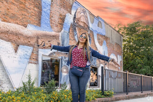 Posing by Benjamin Benson's vibrant downtown mural.
