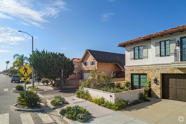 Homes in Island Village have spacious garages underneath Spanish style homes.