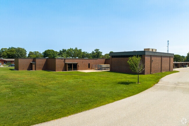 A gravel driveway leads to the side of  Bostic Traditional Magnet Elementary.