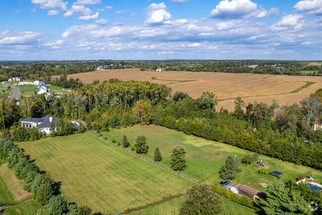 Houses are sprinkled between preserved farmlands.