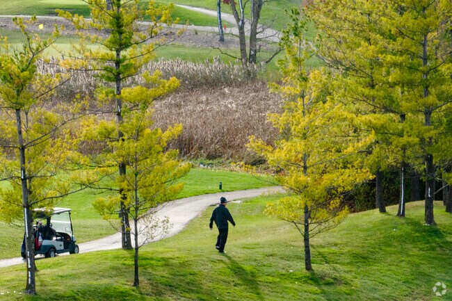 Golfers hunt for their ball in the last light of summer at Stone Wall Golf Club in Lake County.