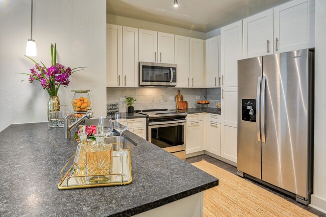Well-appointed kitchens feature granite or quartz countertops and tiled backsplashes