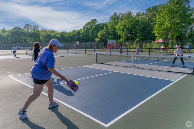 Residents take pickleball lessons at East Village Park in Shelton.