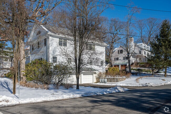 Winding roadways lined with manicured lawns and thick foliage are common in Fox Meadow.
