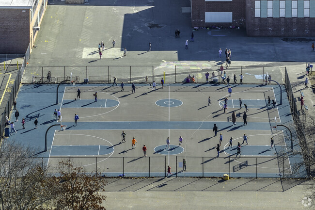 Students play on the basketball courts at John F. Kennedy Elementary School in Canton, MA