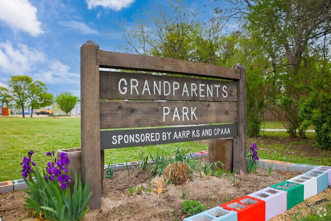 Families enjoy the half-acre of green space at Grandparents Park in East Front/Sunnyside.
