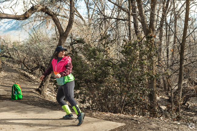 Creekside Park is a popular destination in Holladay for frisbee golf as is seen by this woman.
