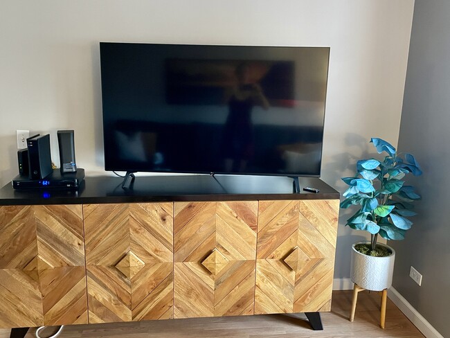 55” LG TV and sideboard.