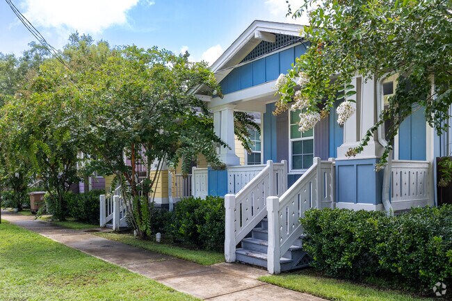 A row of colorful bungalows amid lush crape myrtles in Summerville.