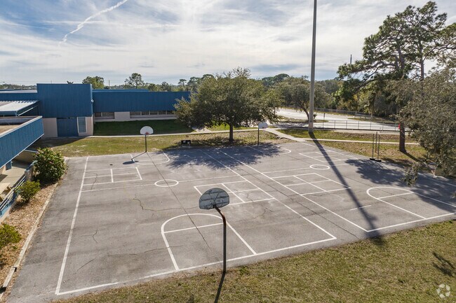 Kids enjoy outdoor play on the sports courts at Gulfside Elementary.