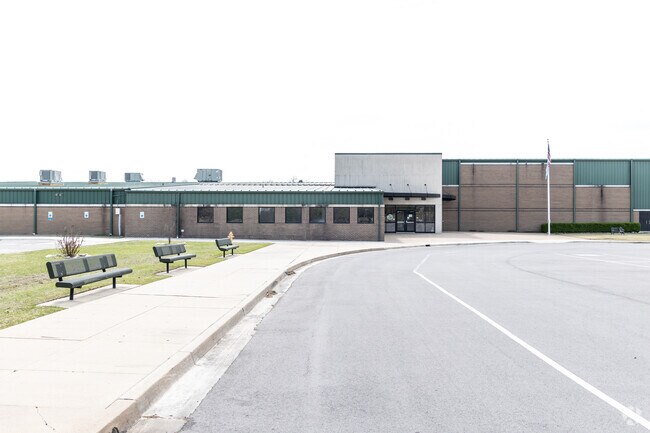 Students can wait for pick ups on the benches outside Owasso 6th Grade Center.