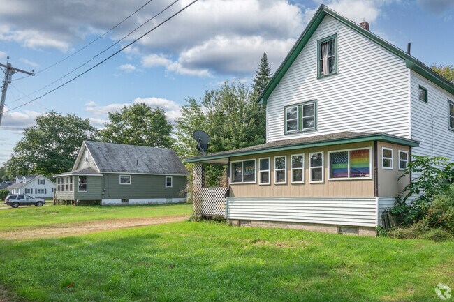 A row of New England style homes line a Howland street.
