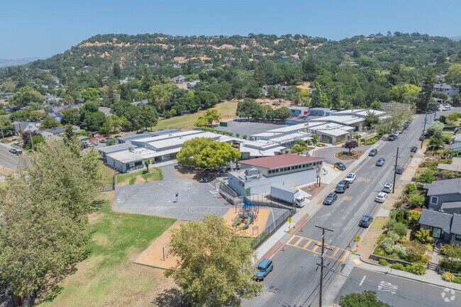 Alta Heights Elementary School has a small blacktop and green field.