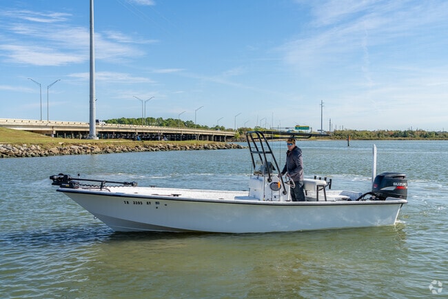 A Baytown fishing guide steers his boat toward the dock.