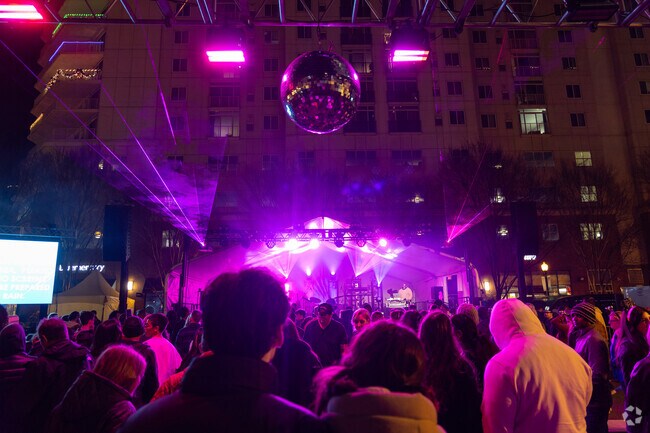The main stage lights shine bright as people celebrate Last Night on the Town in Virginia Be