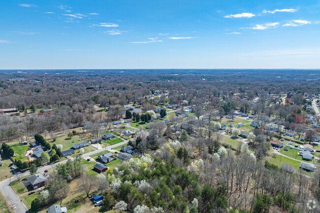 The community Flat Rock is surrounded by beautiful mature trees.