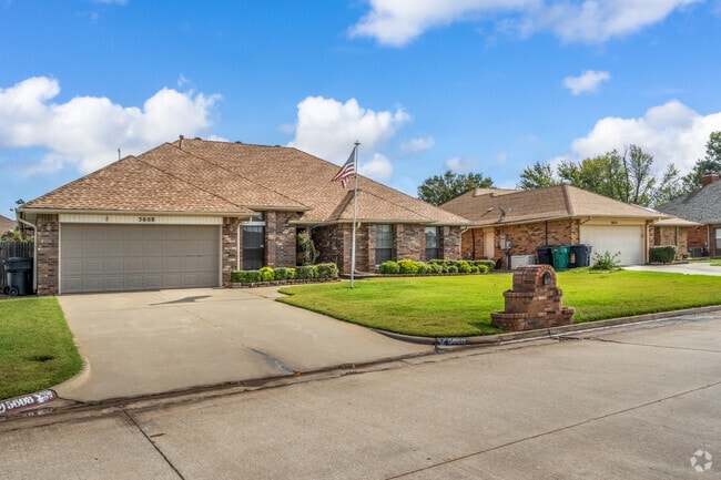 A ranch-style home with an American flag on the front yard in Frolich Meadows Estates.