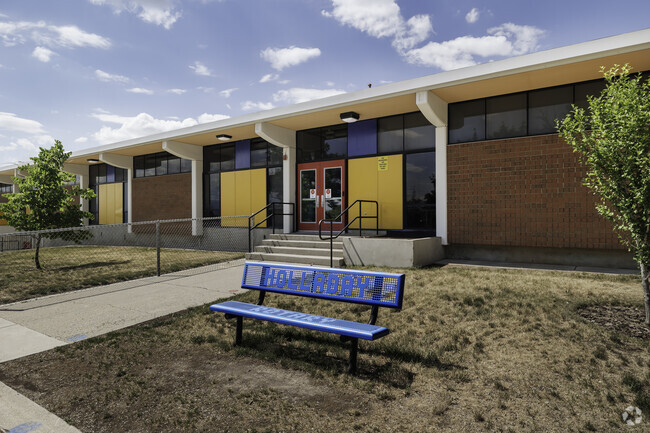 A charming blue bench that spells Holladay Rotary at Howard Driggs Elementary School.