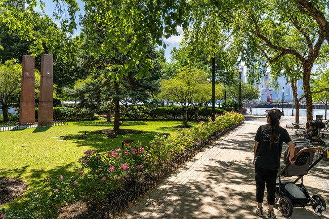 Carer's of children watch as Canada Geese feed in The Waterfront's Newport Town Square Park.